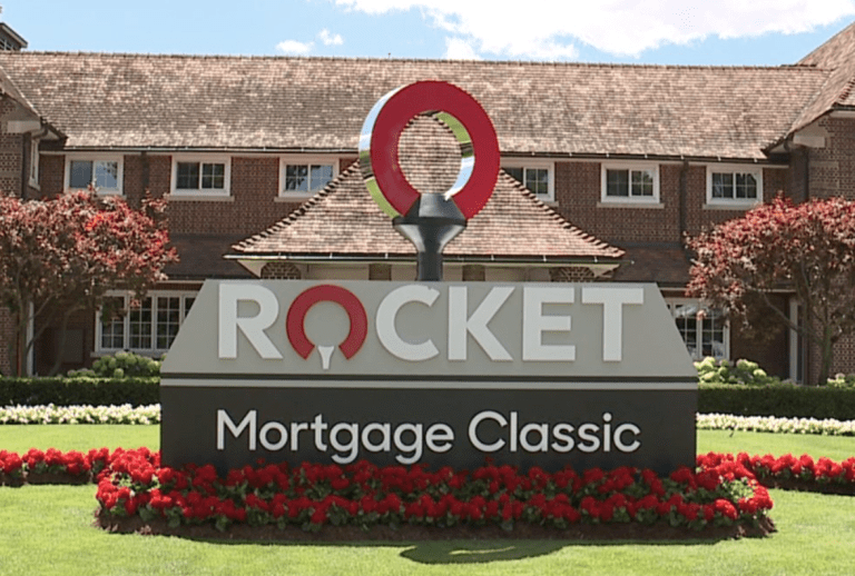 Detroit Golf Club clubhouse with green lawn and clear skies