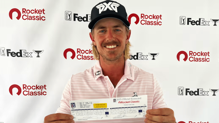 Jake Knapp holds his scorecard after shooting 61 at the Rocket Classic