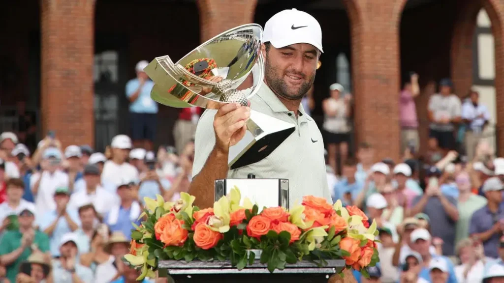 Scottie Scheffler holding the FedEx Cup trophy after winning the 2024 Tour Championship with a record score of −30.